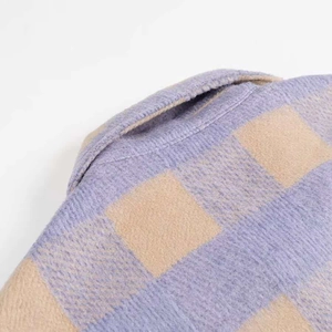 Close-up of the classic collar on a thick plaid flannel shirt jacket in purple and beige