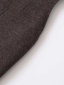 Close-up of the dark grey ribbed knit texture and soft wool blend fabric on a fashion vest