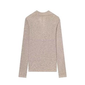 Détail du pull à col roulé marron clair montrant la couture dorsale et la maille fine
