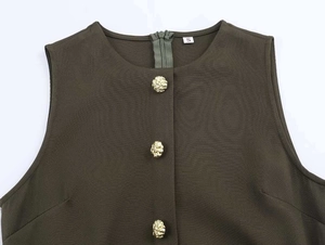 Detail of dark olive sleeveless midi dress featuring gold embossed buttons and round neck