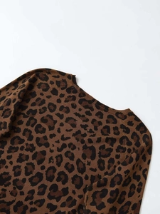 Close-up detail of the crew neck and shoulder on this leopard print knit sweater