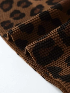 Close-up of leopard print ribbed knit fabric with soft texture and detailed yarn weave