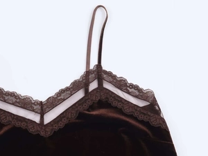 Close-up detail of dark brown velvet camisole with delicate lace trim at the V-neckline