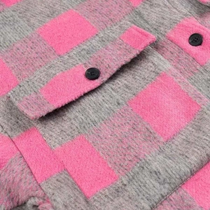 Detailed view of pink and grey plaid woolen jacket featuring pocket flap and black button