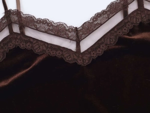 Detailed close-up of dark brown velvet camisole featuring V-neck floral lace and mesh trim