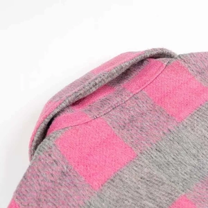 Macro detail of pink and grey checkered wool blend shirt collar with soft texture