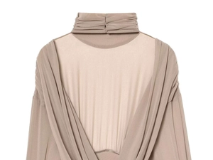 Detail of nude turtleneck bodysuit featuring draped pleats and backless mesh panel design