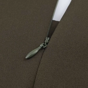 Detail of high-quality invisible zipper on a woven midi dress with water-drop puller
