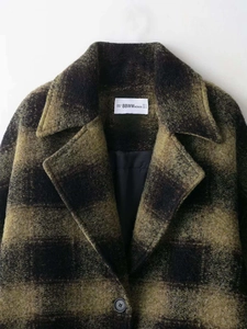 Detail of wool coat collar with green plaid pattern and BBWMwoman size label