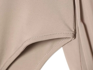 Detailed view of the precise curved hem stitching on this nude high-neck bodysuit