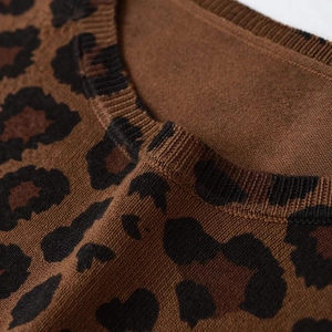 Women's leopard print knit sweater featuring a ribbed crew neck and soft brown fabric