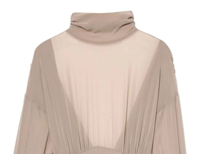 Detailed view of nude high-neck bodysuit featuring sheer mesh panels and pleated fabric