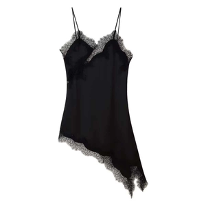 Detail of black satin slip dress showing delicate eyelash lace and asymmetric hemline