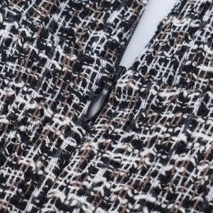 Sleeveless grey textured dress with invisible zipper and elegant woven tweed fabric details