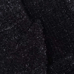 Close-up of black metallic tweed fabric with shimmering silver lurex threads