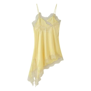 Close-up of delicate lace embroidery and yellow satin fabric on an asymmetric dress