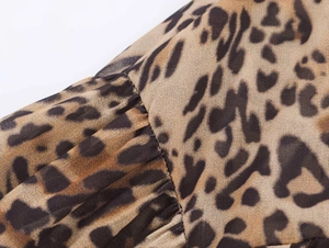 Macro shot of leopard print fabric with delicate pleated details and chiffon texture