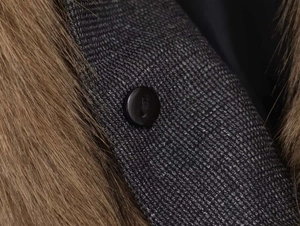 Macro shot of faux fur collar and textured wool blend coat with a round resin button