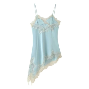 Close-up of light blue satin camisole with cream lace trim and asymmetric hem detail