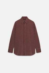 Detail shot of the red and black striped shirt featuring the collar and button-down front