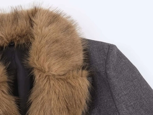 Close-up of brown faux fur collar and gray textured fabric on women's blazer