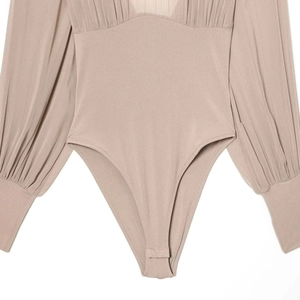 Slim fit nude long sleeve bodysuit with pleated sleeves and snap closure at the bottom