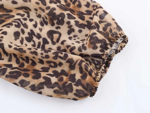 Detail shot of leopard print dress sleeve with elastic cuffs and sheer chiffon fabric