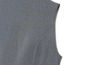 Detail view of grey vest featuring premium twill fabric texture and precise stitching