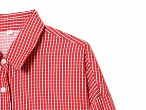 Close-up detail of red and white striped shirt collar with size L label and neat stitching