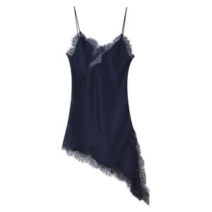 Close-up of dark blue satin slip dress with V-neck lace detail and asymmetric hemline