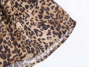 Detailed close-up of leopard print dress hem featuring neat stitching and airy fabric