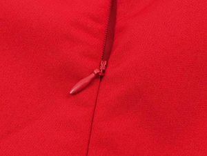 Detail of red blazer fabric texture with invisible water-drop zipper closure