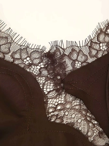 Close-up of brown lace neckline detail on an asymmetrical camisole summer dress