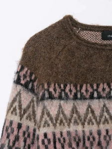 Close-up of the fuzzy mohair knit sweater with pink and grey geometric patterns