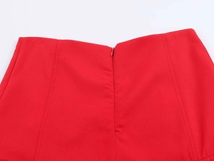 Detailed view of red skirt featuring high-waist design and invisible zipper closure
