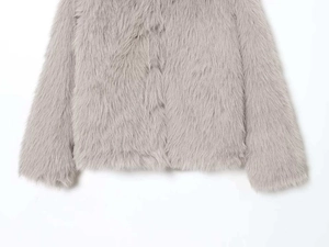 Detailed close-up of light gray faux fur coat texture on hem and sleeve cuffs