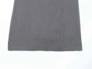 Detailed close-up of gray dress hemline showing precision stitching and fabric texture