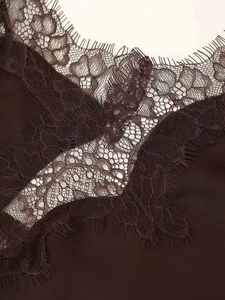 Detail of coffee satin dress with delicate floral eyelash lace trim on the neckline