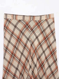Detailed close-up of plaid midi skirt showing cotton linen texture and orange check pattern