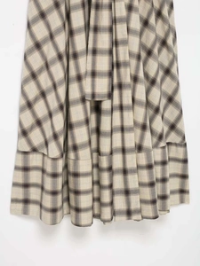 Detail of plaid print dress with ruffled hem and breathable cotton-linen fabric texture