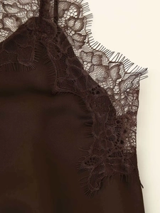 Detailed close-up of coffee brown silk camisole with delicate eyelash lace trim at neckline