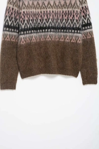 Close-up of Fair Isle geometric jacquard pattern on a warm brown fuzzy knit sweater