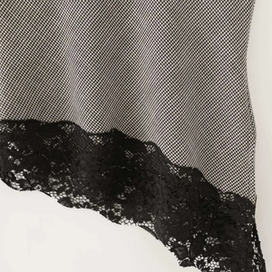 Houndstooth sleeveless top with intricate black lace hem detail and high neckline