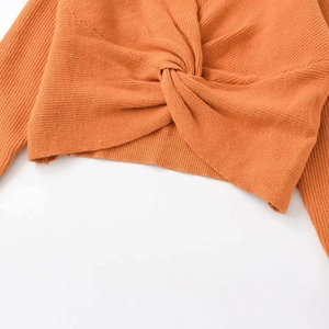 Chic orange ribbed knit top featuring a stylish front knot detail for women