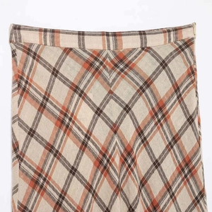 Plaid midi skirt in warm orange and brown tones with a seamless hidden side zipper