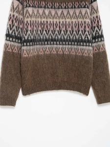Detailed view of Fair Isle geometric knit pattern and soft texture on brown sweater