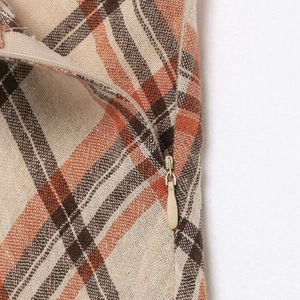 Plaid midi skirt with vintage check pattern and invisible zipper detail in brown and orange