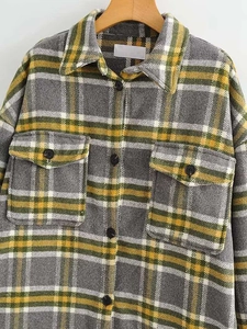 Detailed view of the yellow plaid wool-blend shirt featuring buttoned flap chest pockets
