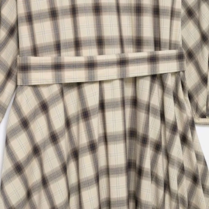 Chic beige plaid dress with round neck and matching waist belt for a stylish summer look