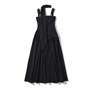 Detail of elegant black halter neck maxi dress with layered bodice and pleated skirt